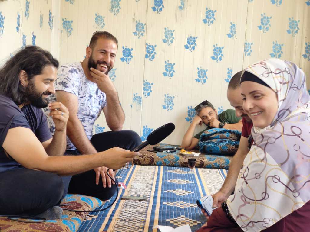 Mohsin in Zaatari refugee camp recording ‘The Understory' with community leaders of #MeWeSyria Nadine and Alaa, 2022.